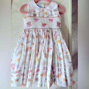 Bella Bliss Tea time party dress. White scalloped collar. Pastel design. Smocked